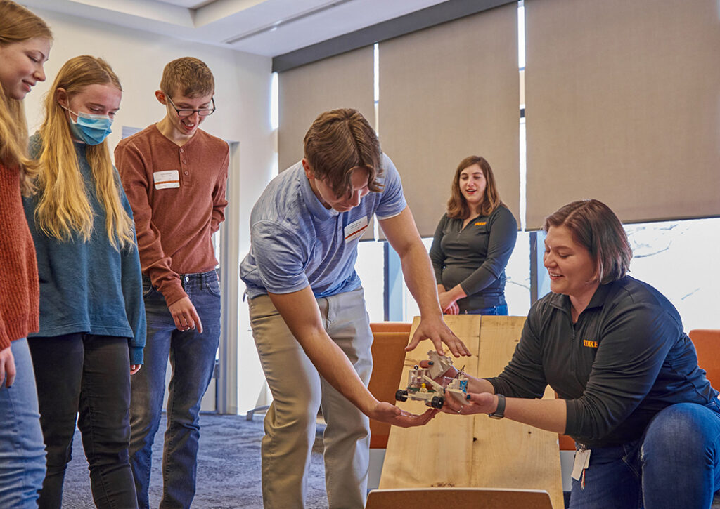 Timken's Joanna Hallisy guide students through a project.