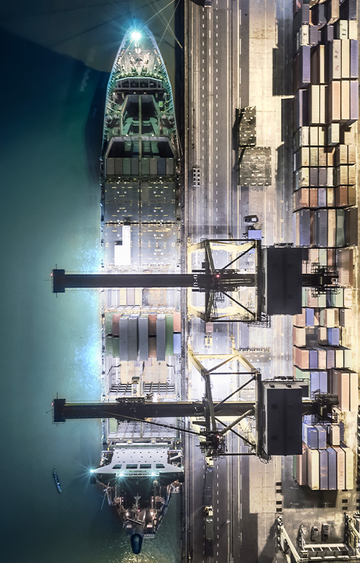 A view of cargo ship being loaded in harbour.